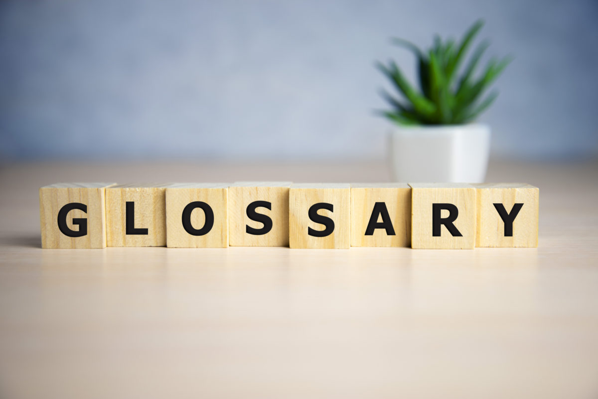 A close up of the word glossary written in wooden blocks